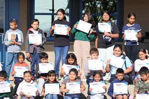 April GRIT students, holding up awards