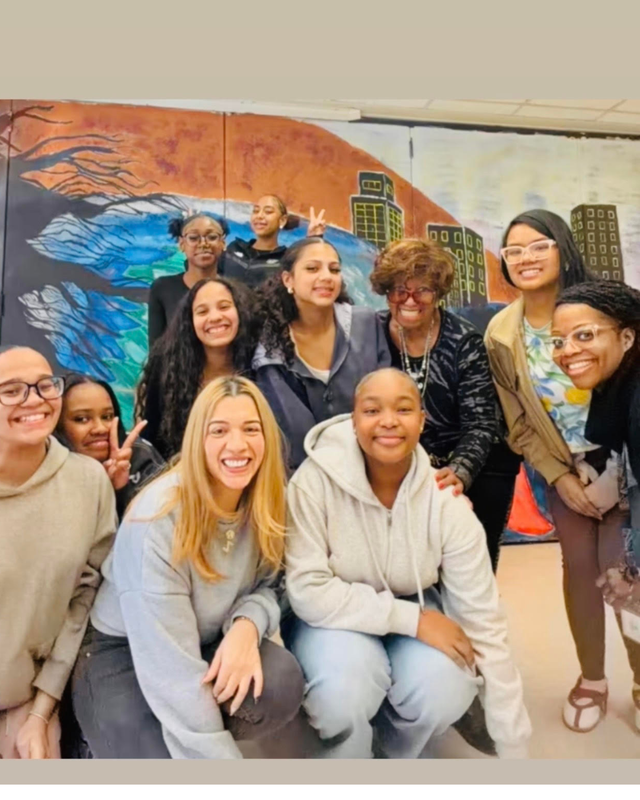 Girls gather with Ms. Spells during Girls Club meeting