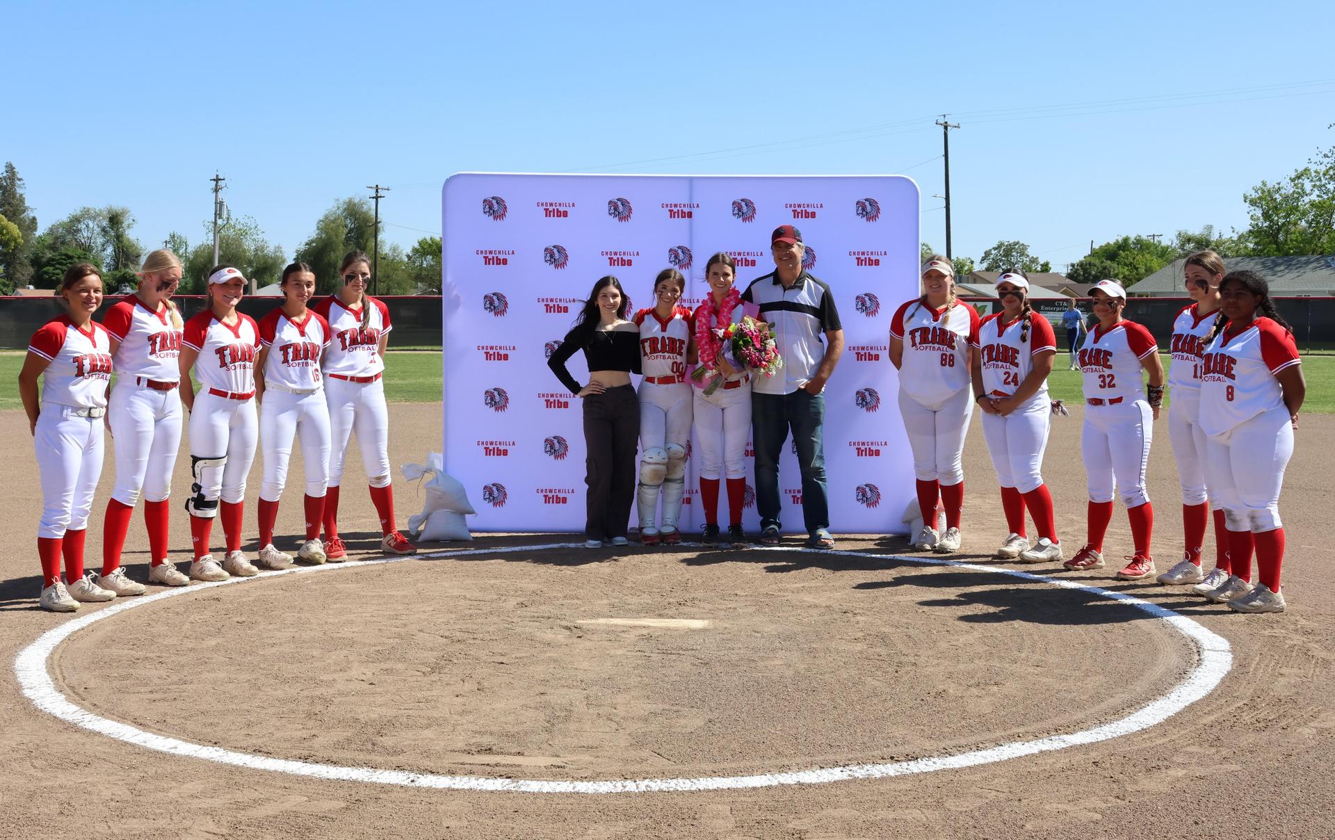 Seniors Posing With Teammates, Coaches, And Family