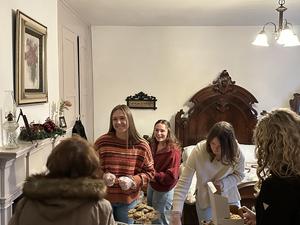 members of history society smiling while passing out cookies