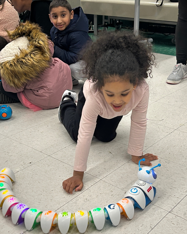 Student plays with games on floor