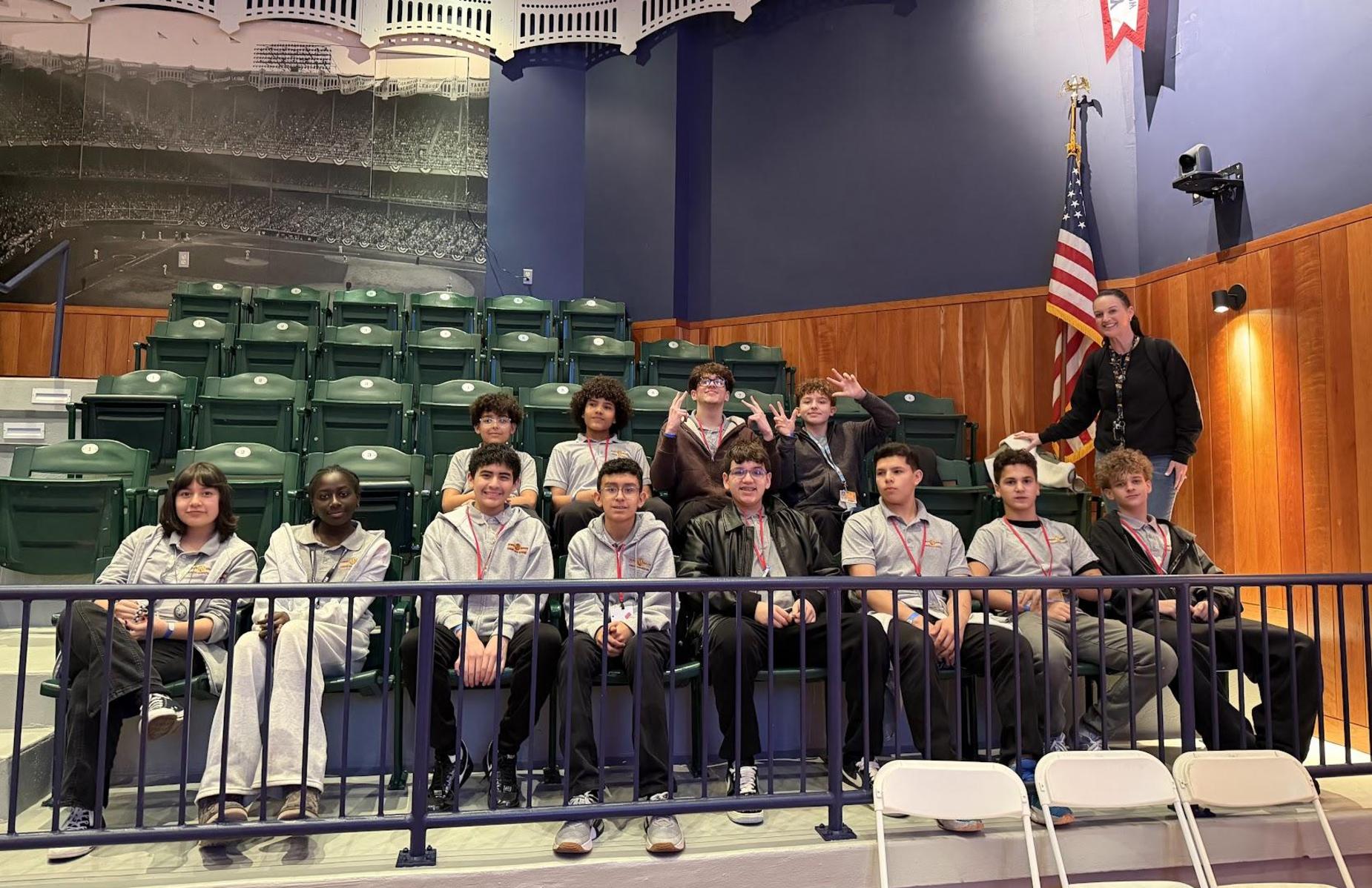 students in stadium seats at the museum