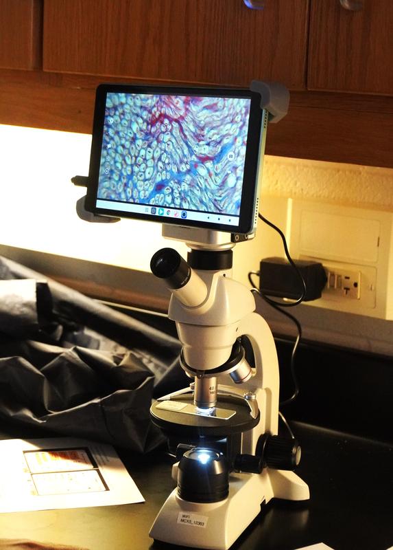 The new microscopes include a connected tablet for easy viewing.