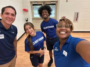 Image of four members of the Booster.com team smiling.