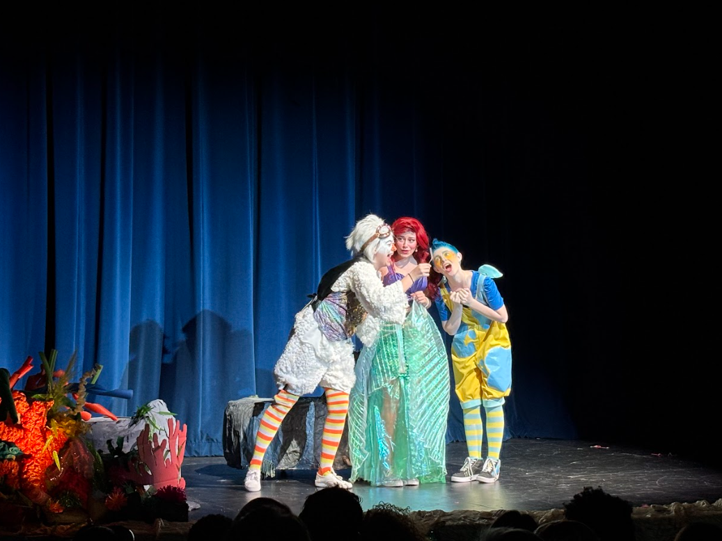 students on stage for theater playing the Little Mermaid