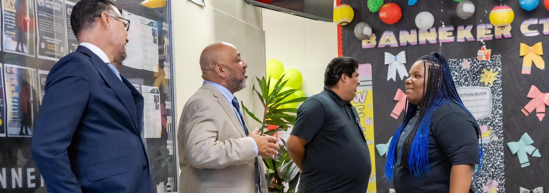 Mr. Leau greeting with students