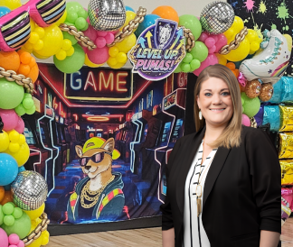 Chelsea Byrd standing in front of retro arcade hallway display