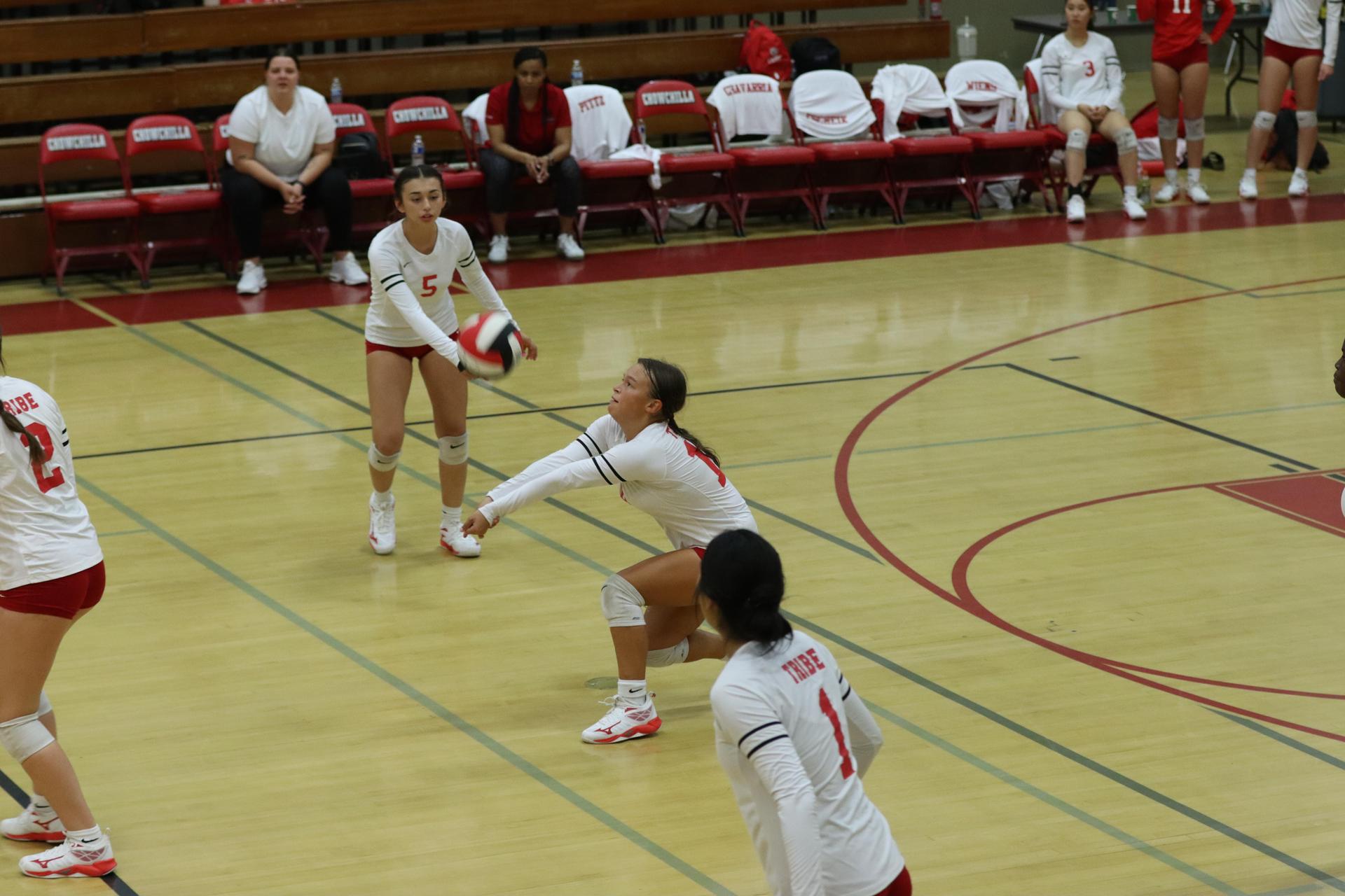 varsity volleyball players in action against liberty