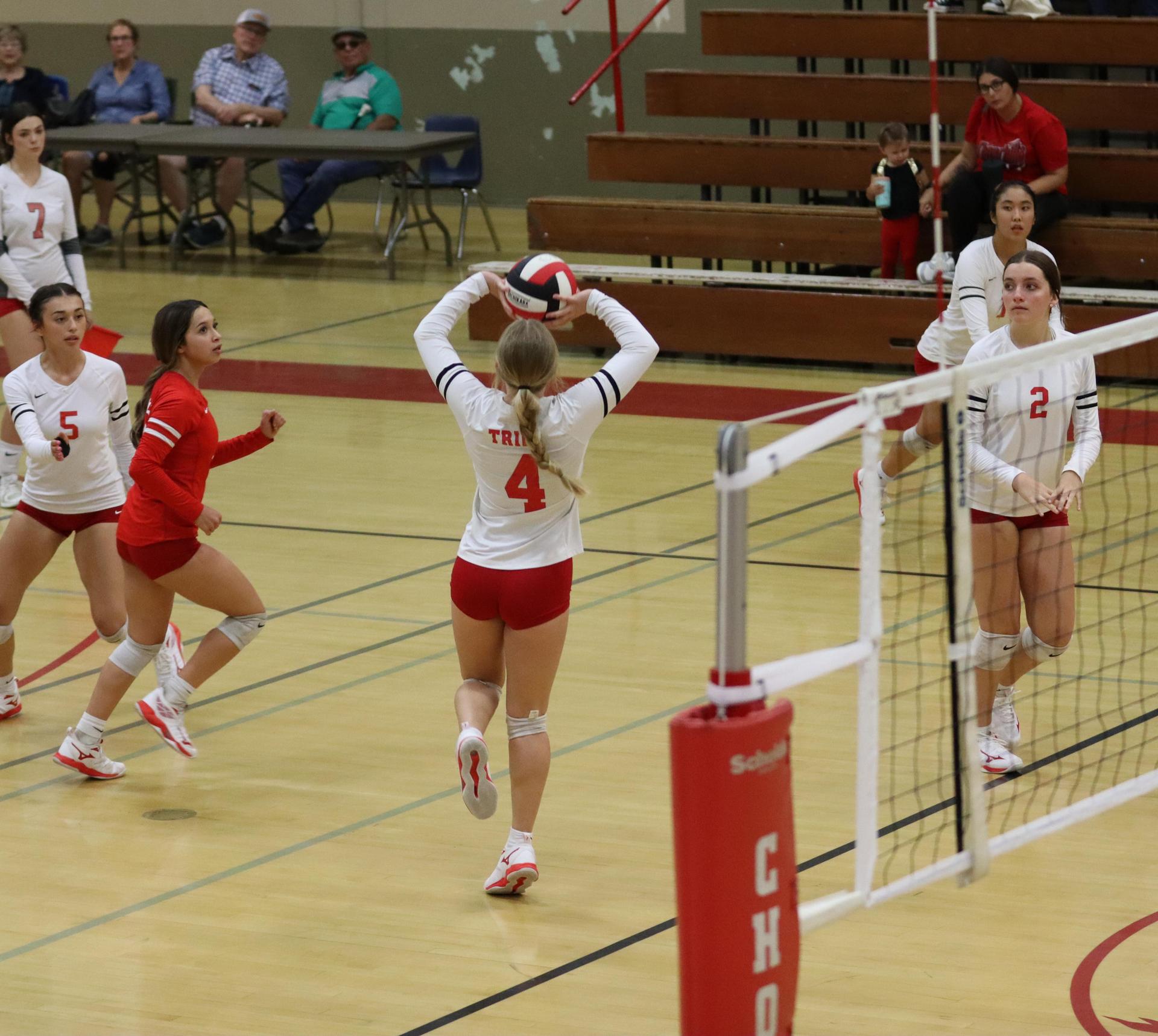 varsity volleyball players in action against liberty