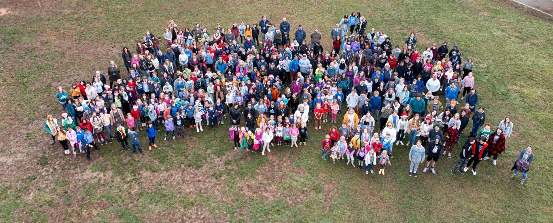 Drone photo of the student body gathered on a field
