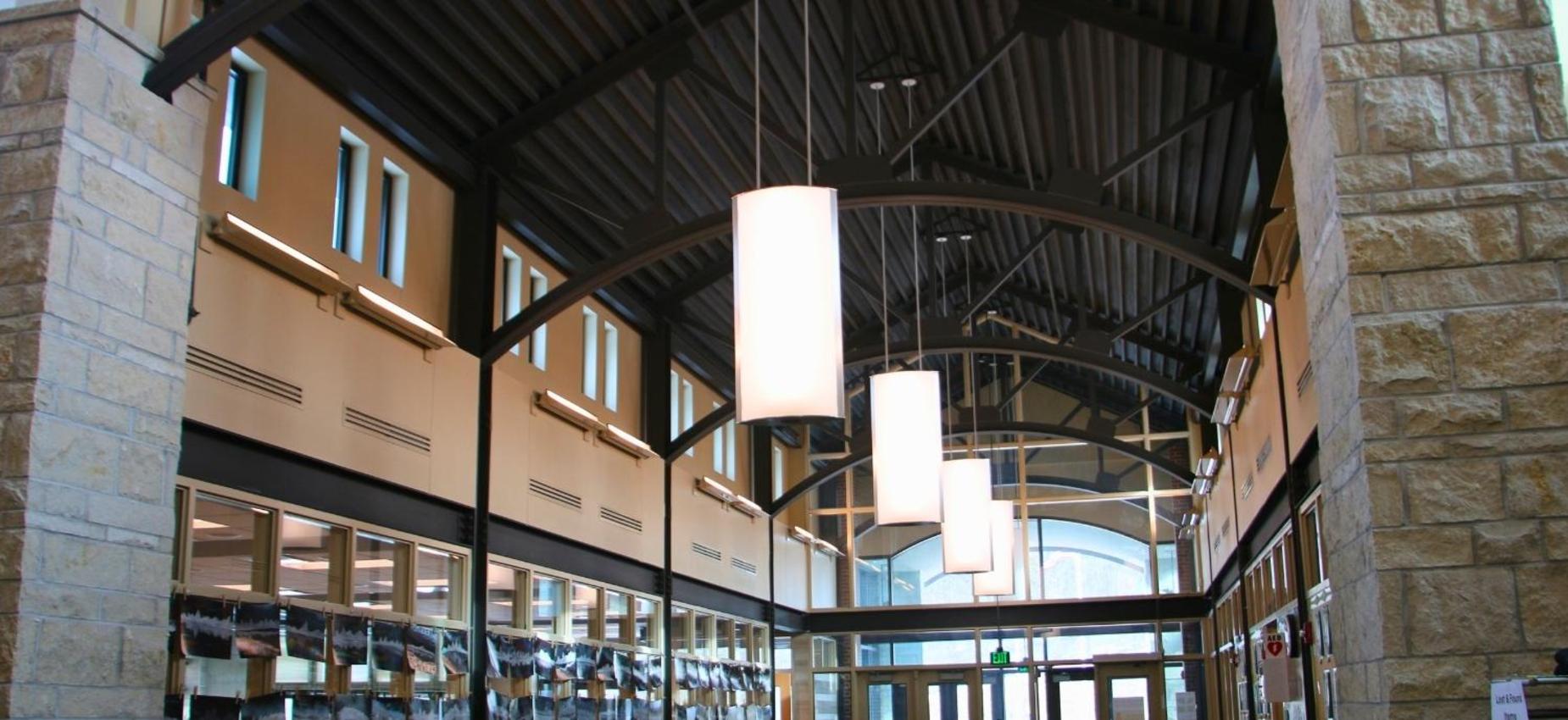 Spacious indoor area with high ceilings and hanging lights.