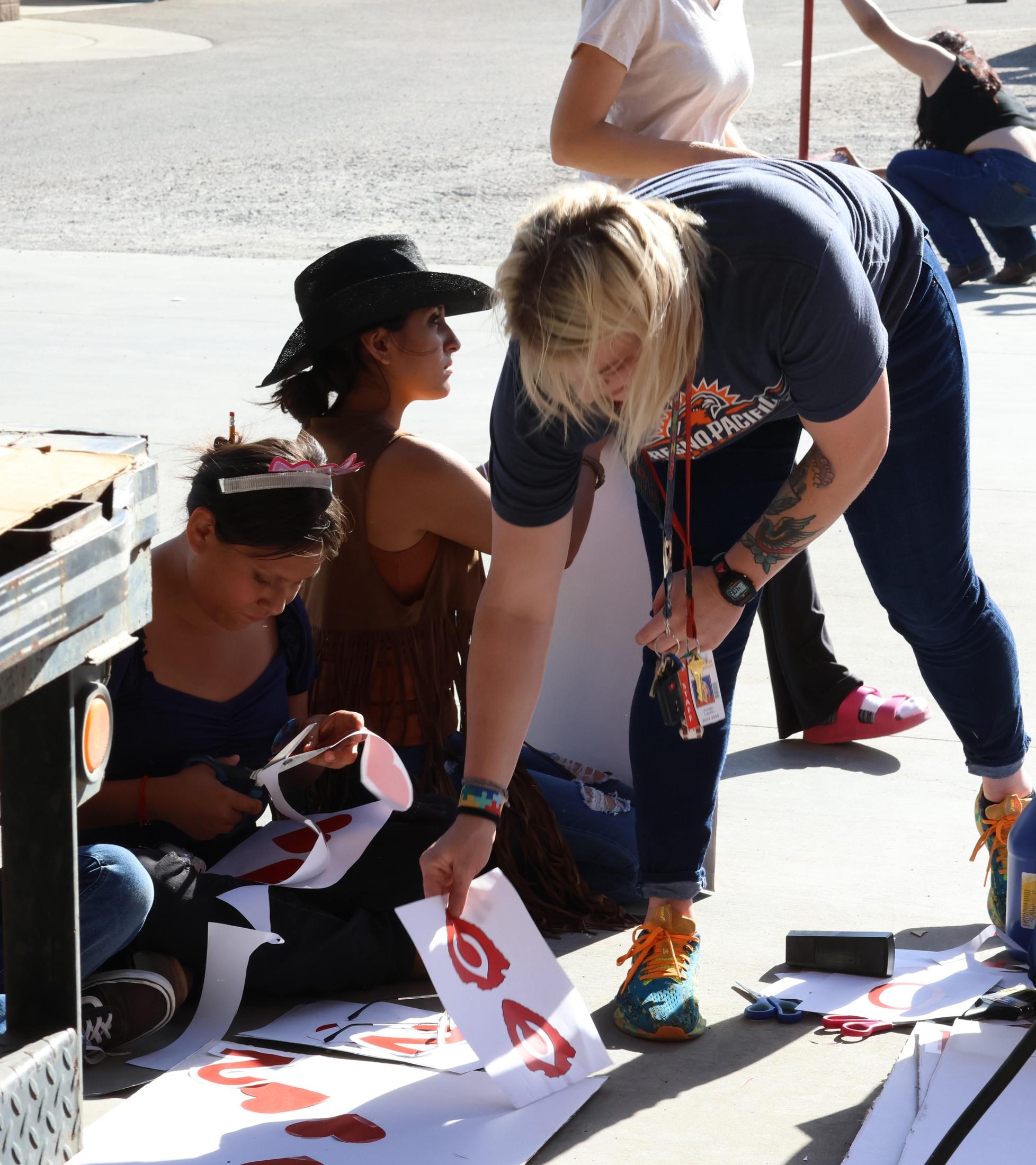 students, parents, and staff building floats for homecoming