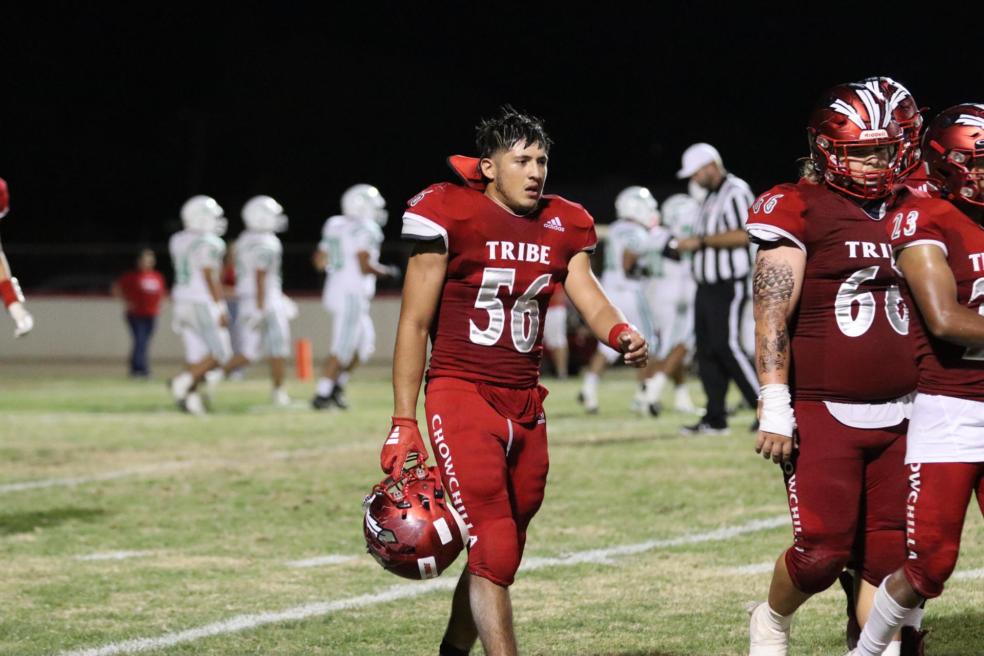 varsity football players in action against Riverdale