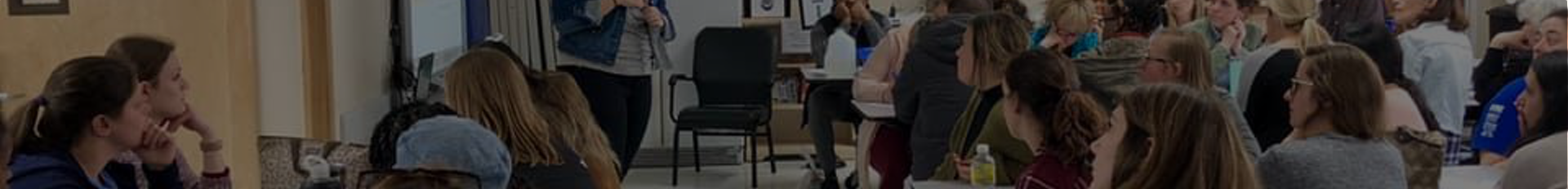 A group of people attending a presentation, focused on the speaker.