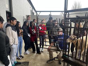 Ag Science teacher with goat talking to students