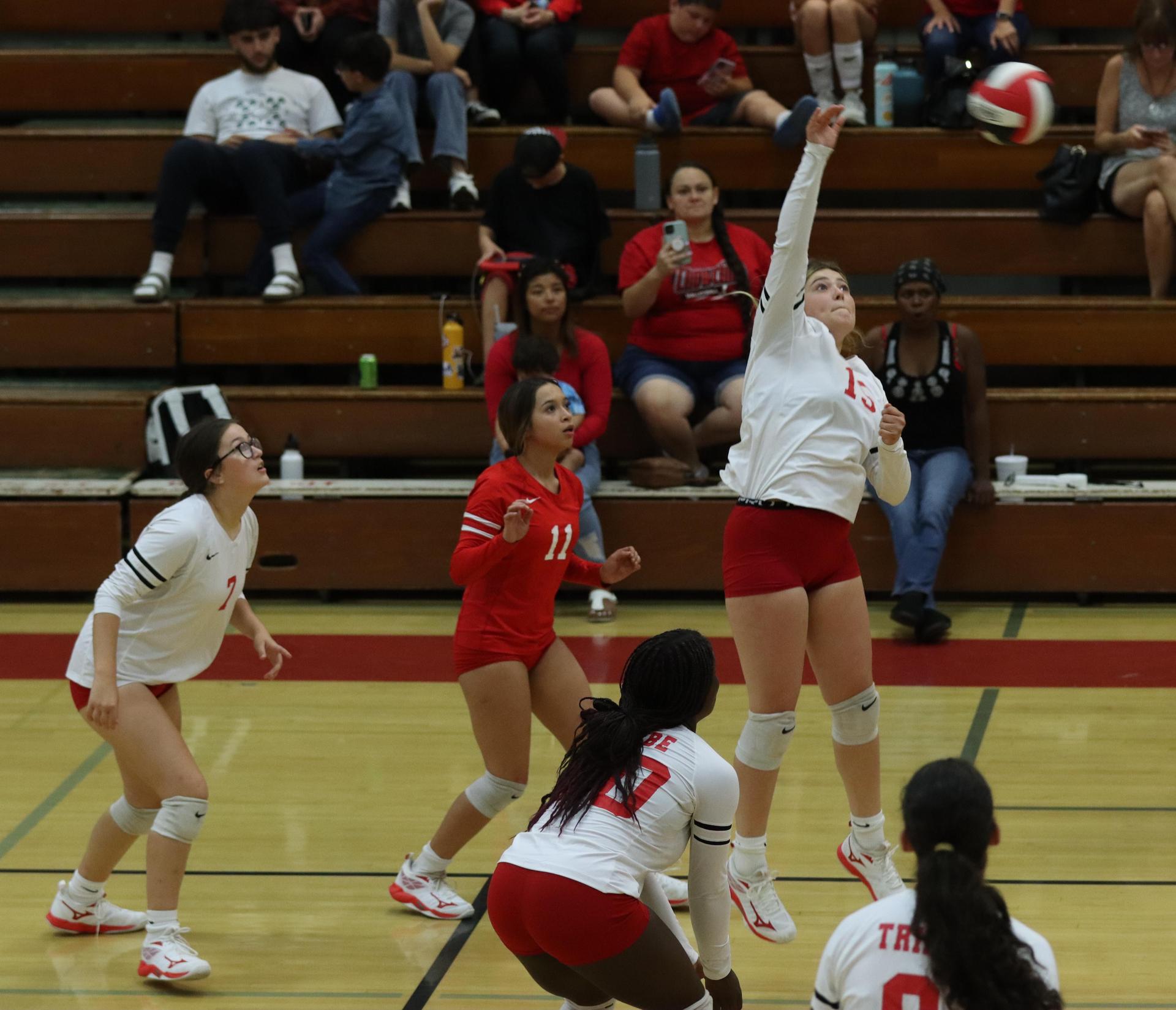 varsity volleyball players in action against golden valley
