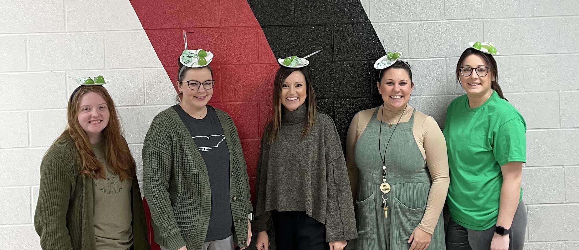 group of female teachers wearing green eggs and ham headbands for dr. suess birthday