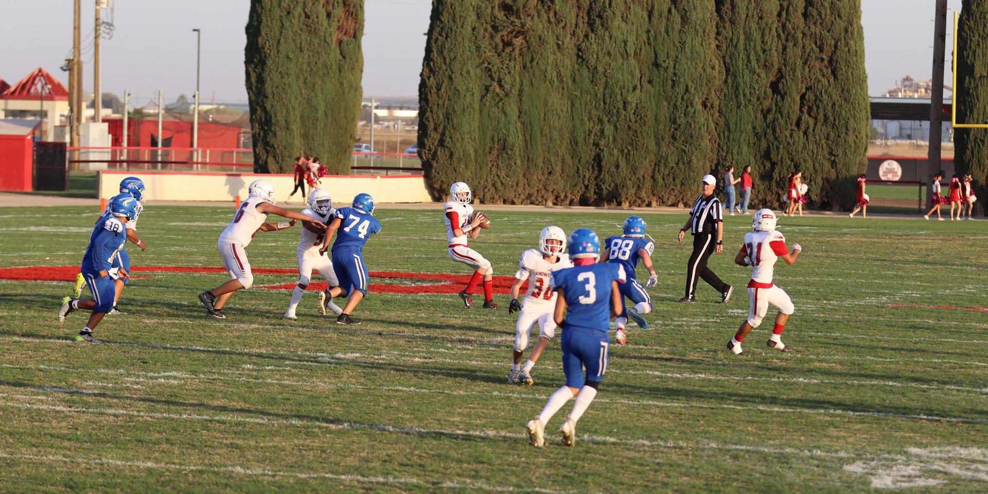Junior Varsity football players in action against Caruthers