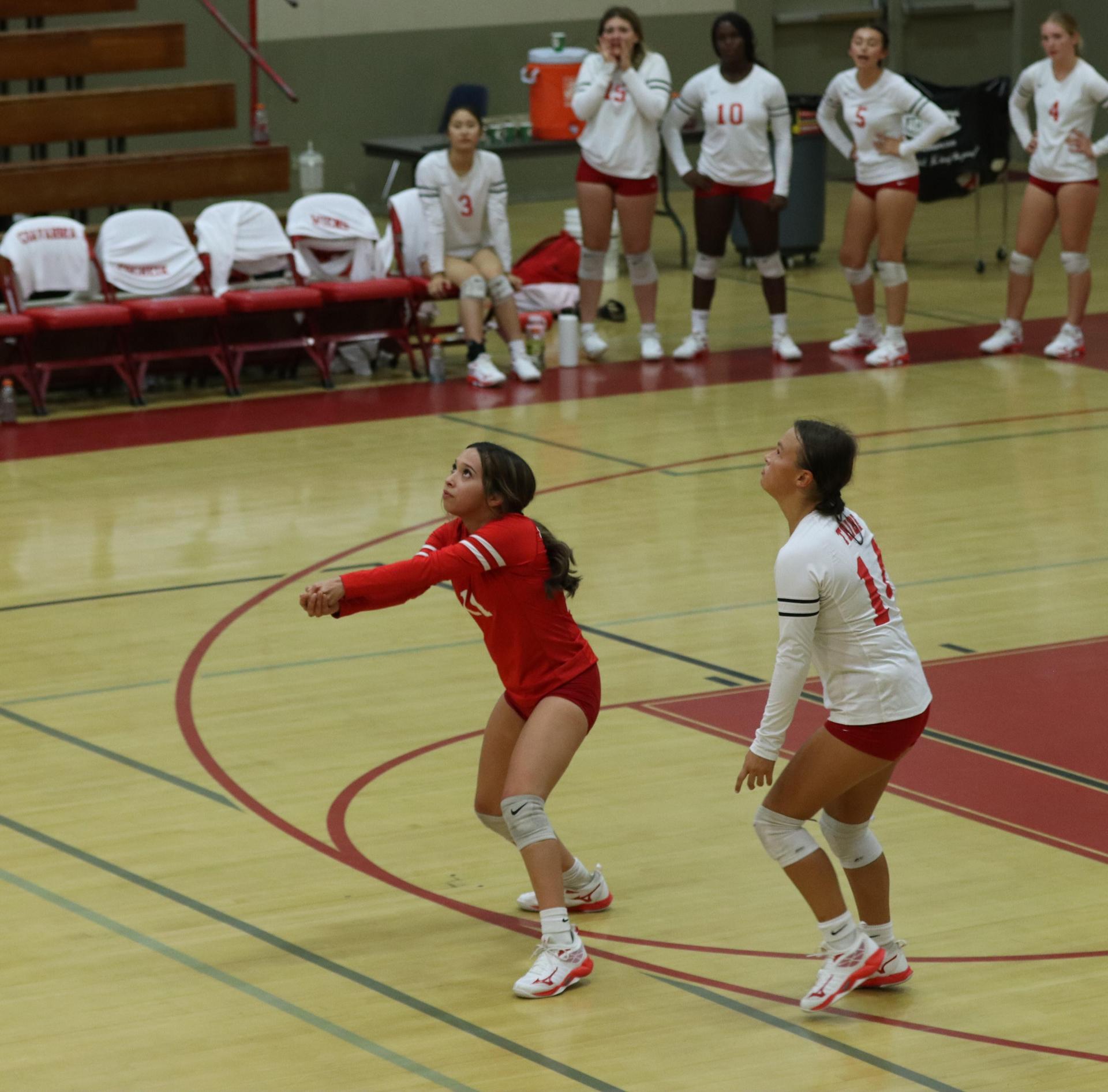 varsity volleyball players in action against liberty
