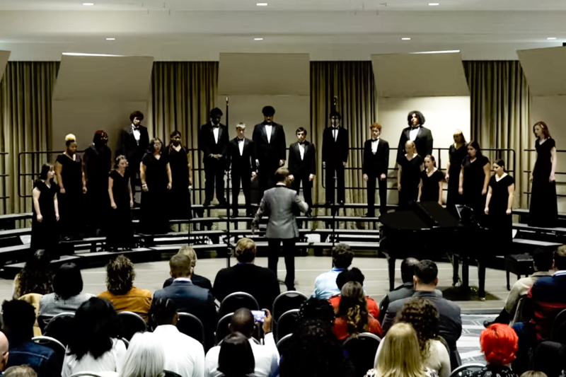 Prince George High School's choir stands and performs at the conference.