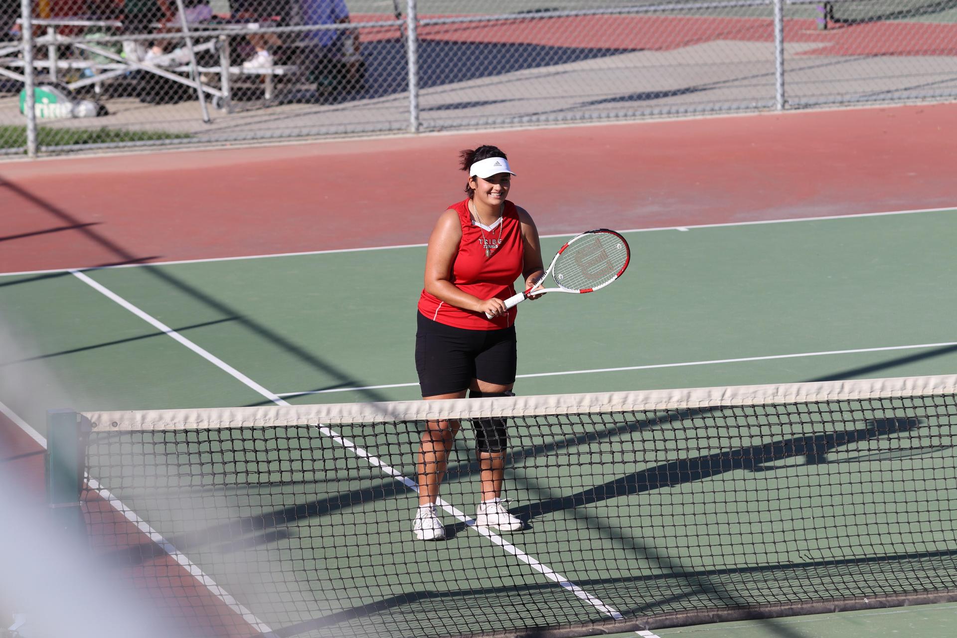 tennis players, family, and staff celebrating senior night