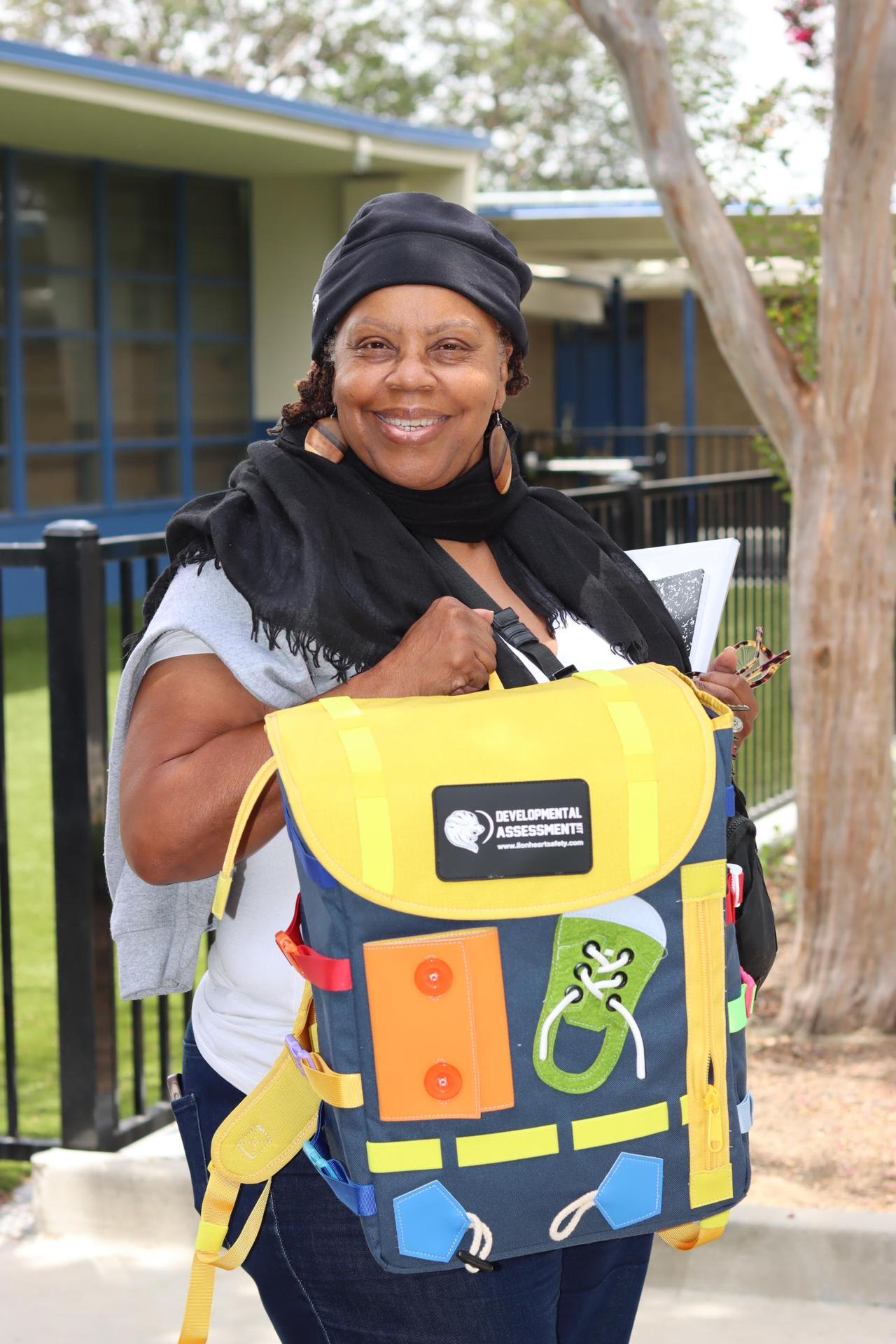 student holding backpack