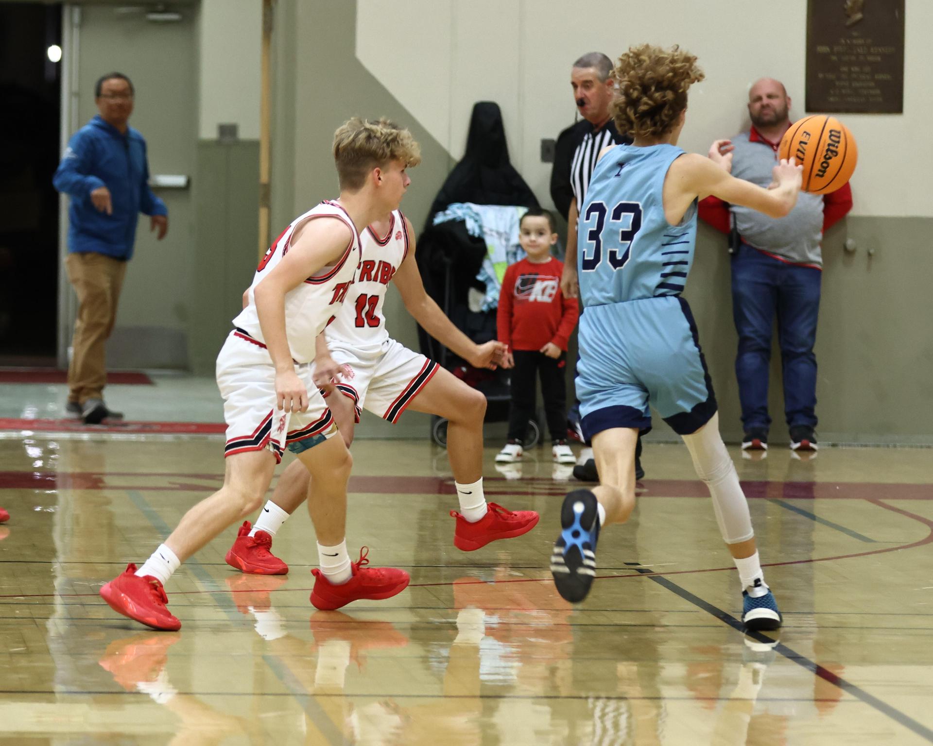 Varsity boys playing basketball against yosemite