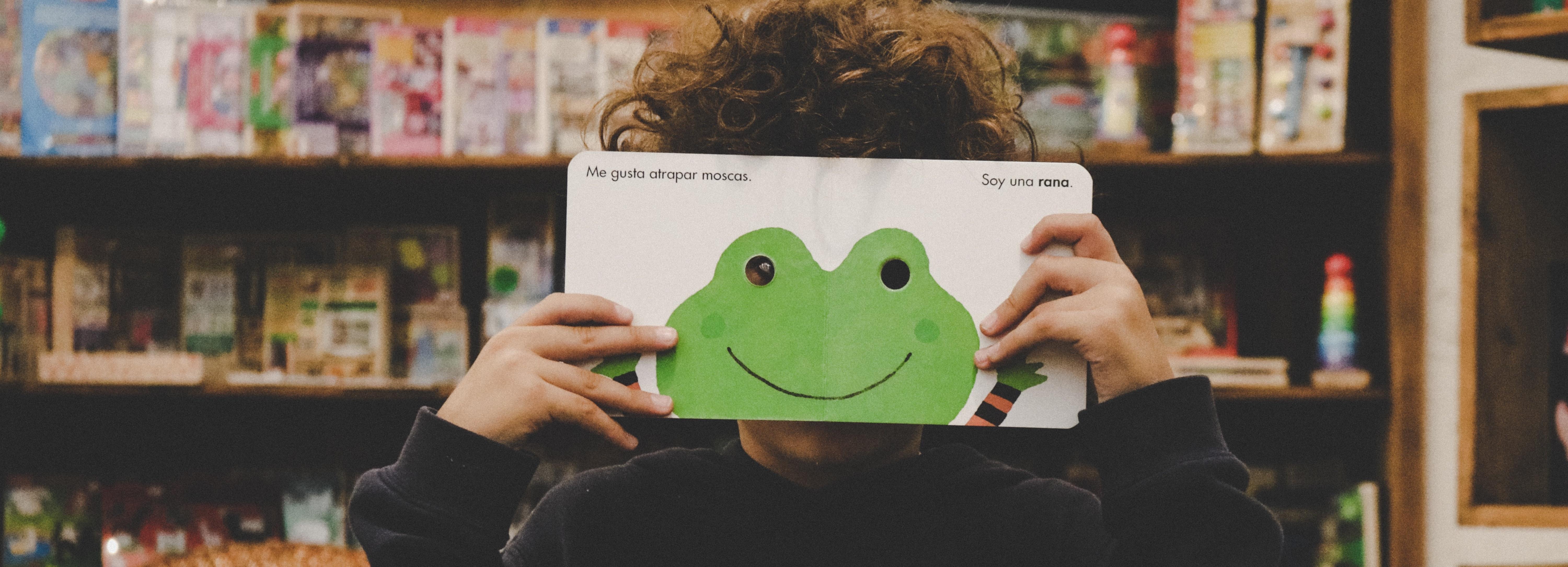 frog book in front of child's face