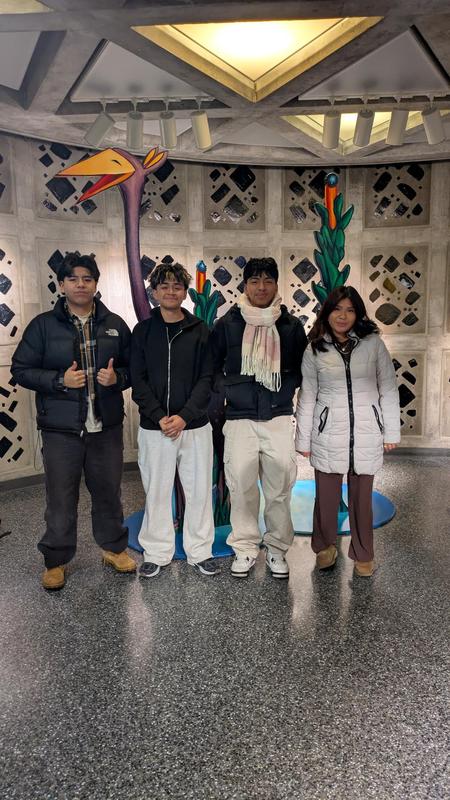 Four students posing with game characters