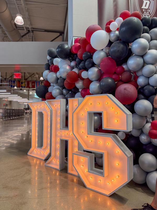 -Davenport High School balloon wall with light up letters spelling 'DHS.'