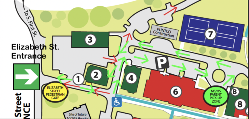 Map showing entrance and pedestrian paths with directional arrows and buildings labeled.
