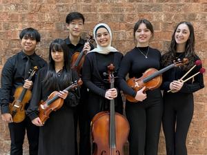 Image of 6 high school orchestra members holding their violins