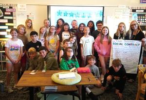 A classroom of students holding their class social contract.