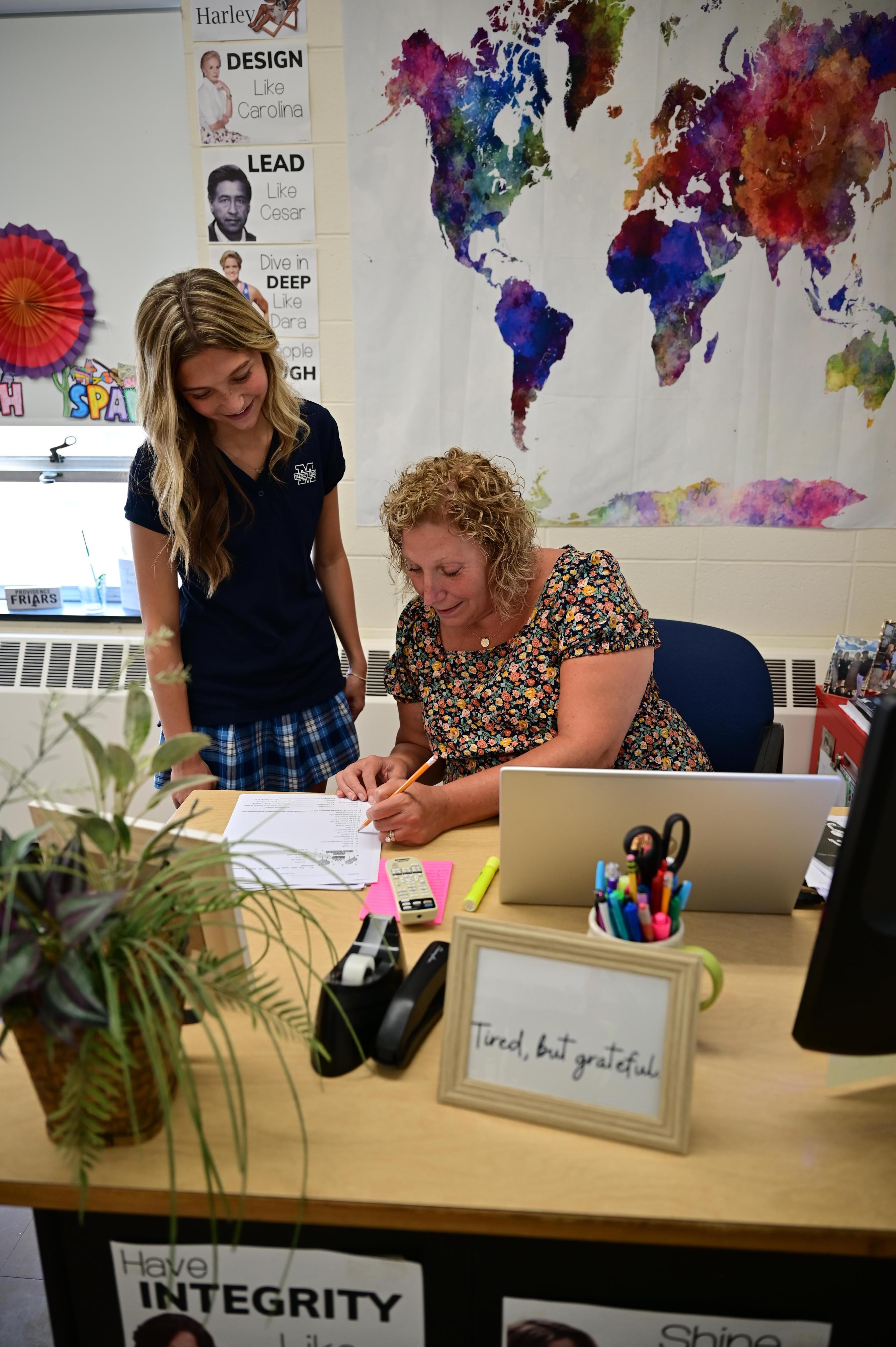 A student is helped by a teacher