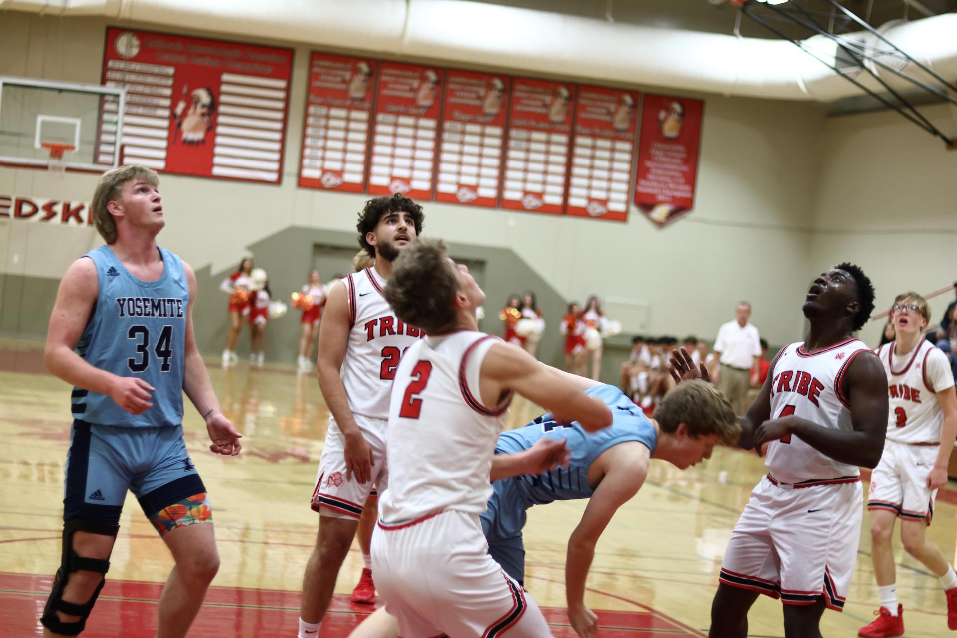 Varsity boys playing basketball against yosemite