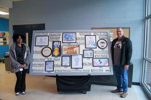 Keny'ce and Mr. Beard pose with mural