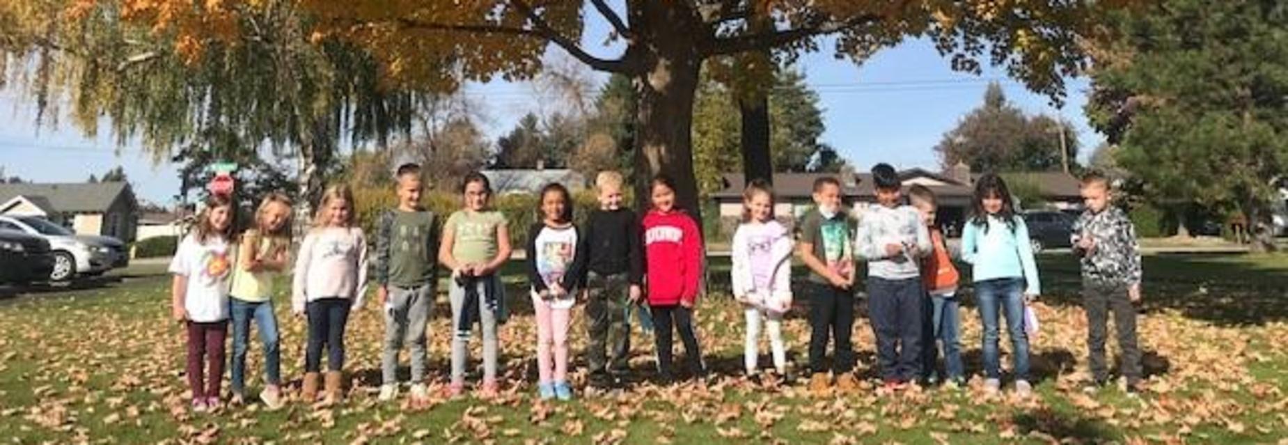 Kids in fall leaves