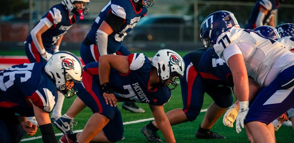 DSD Homecoming Football game shows players in action during a game on a green field.
