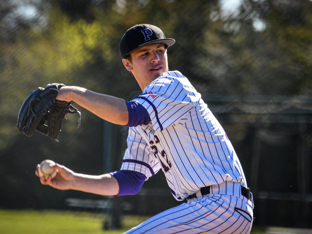 A baseball pitcher about to throw the ball.
