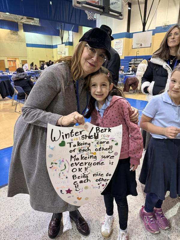 Posing with their family shield