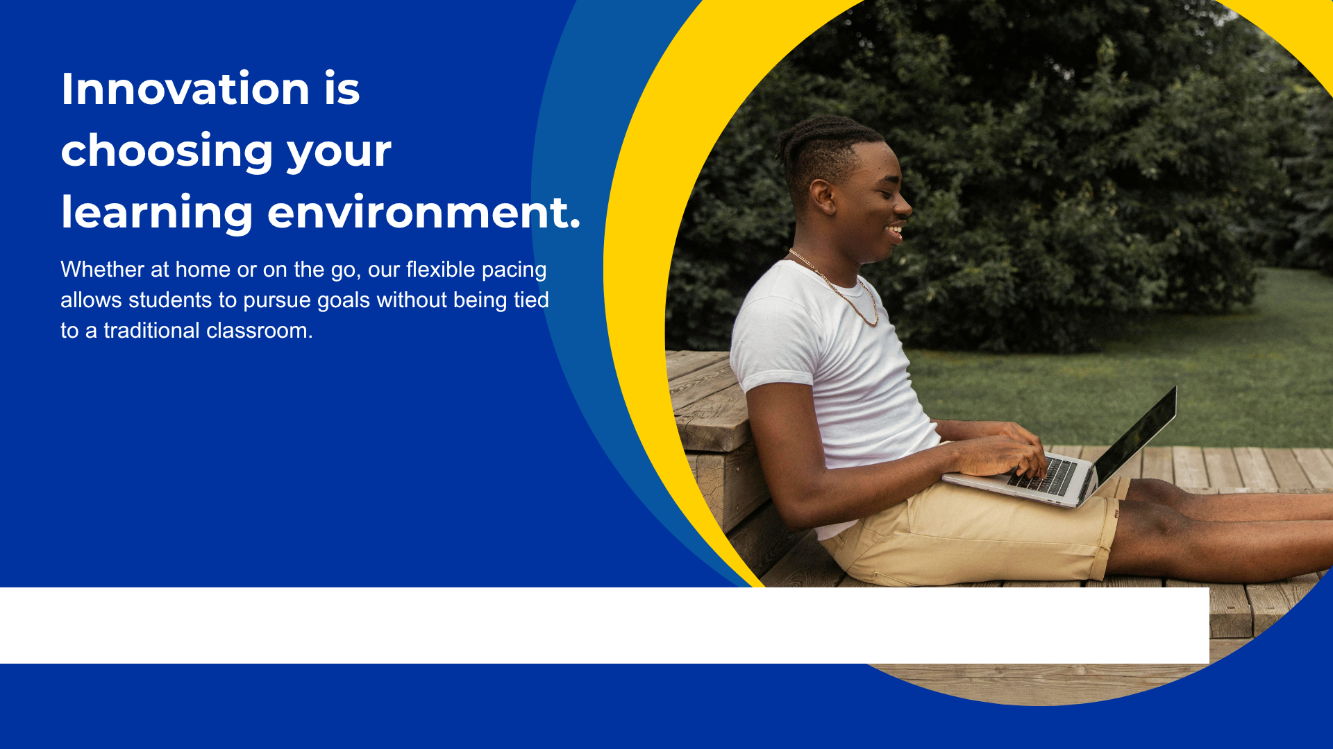 Young man sitting outside with a laptop, engaged in online learning.