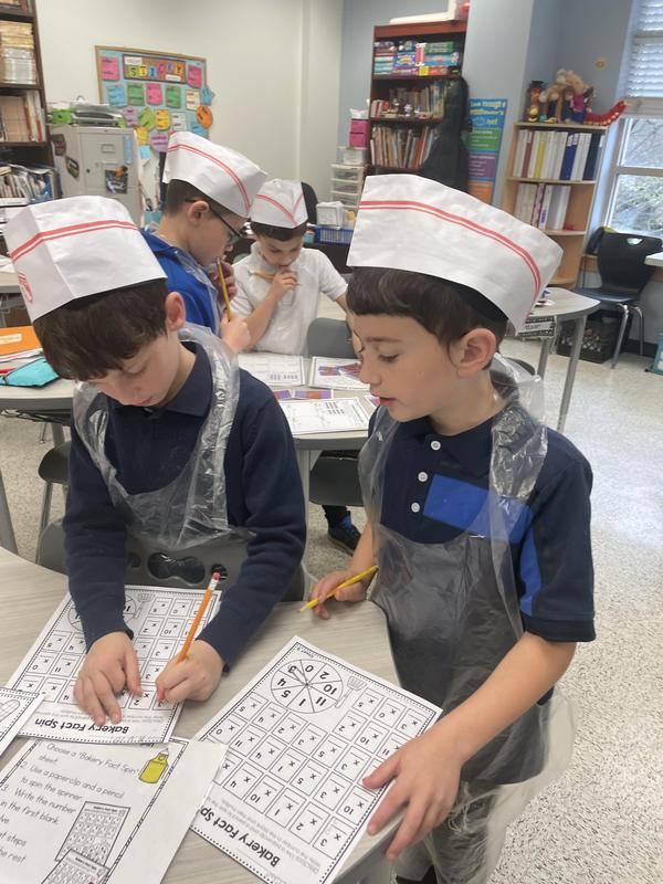 two boys working together at the math  bakery.