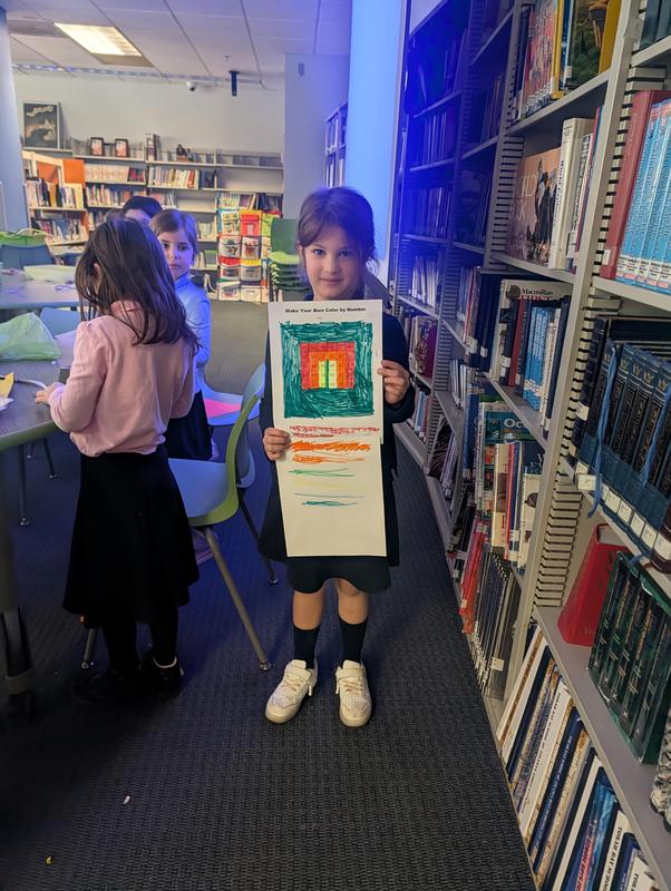 A girl shows off the Color by number that she "invented."