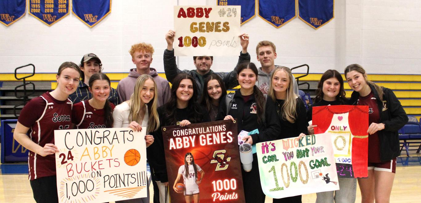 Serra students celebrate with Senior Abby Genes after she scored her 1,000 career point with the Serra Catholic girls basketball team.