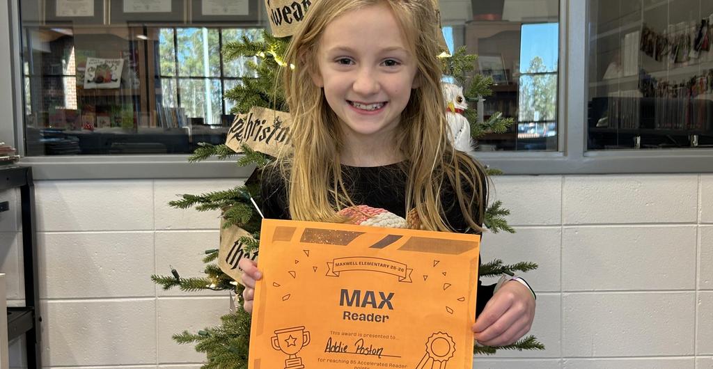Girl smiling with Max Reader certificate