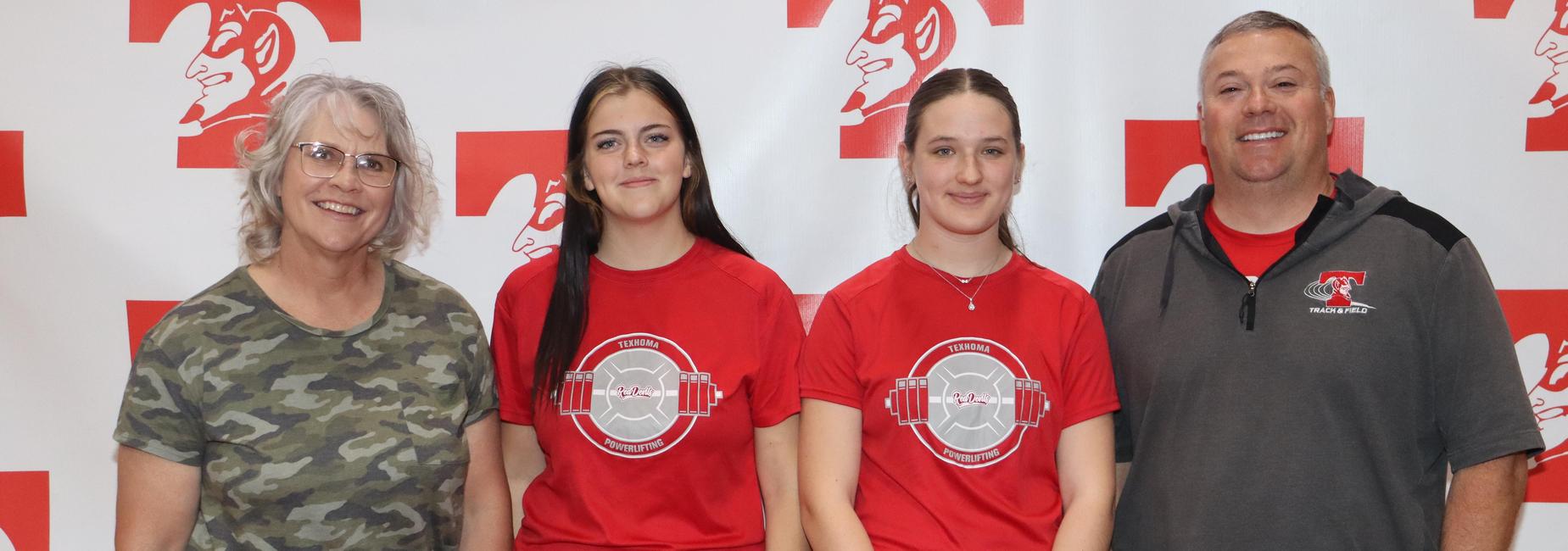 Three individuals, two young women and an adult man, in red and gray shirts.