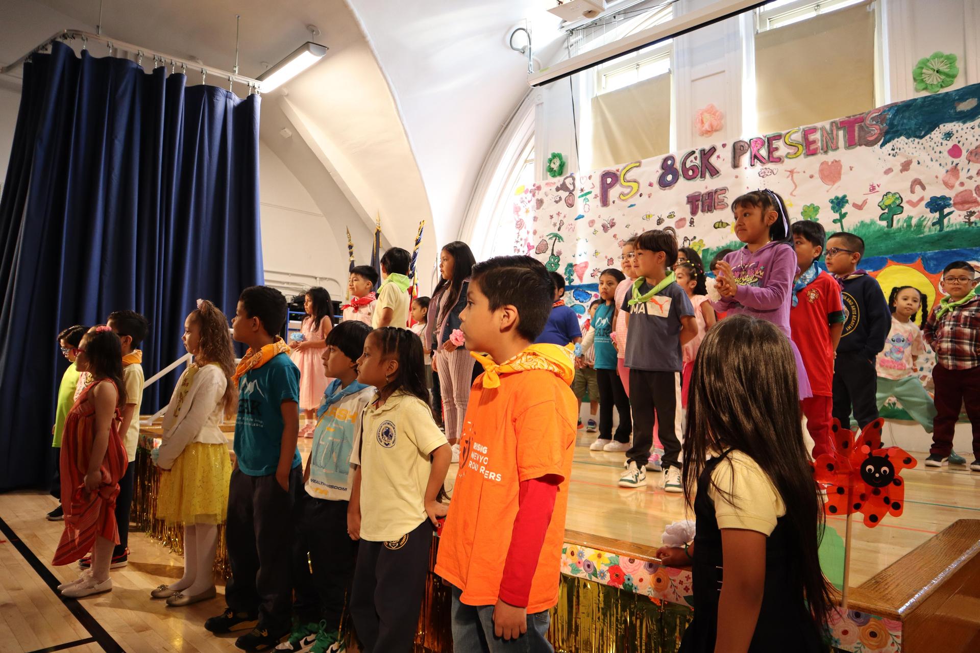 group of students singing on a stage