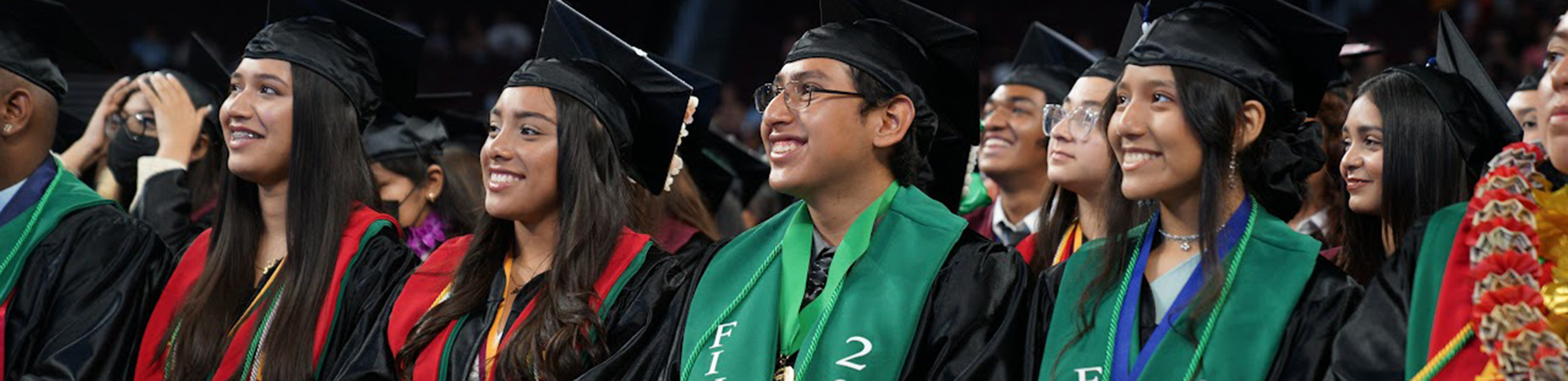 high school graduates in caps and gowns