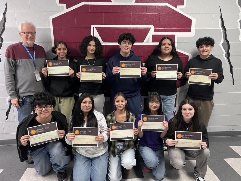 Smiling students holding certificates
