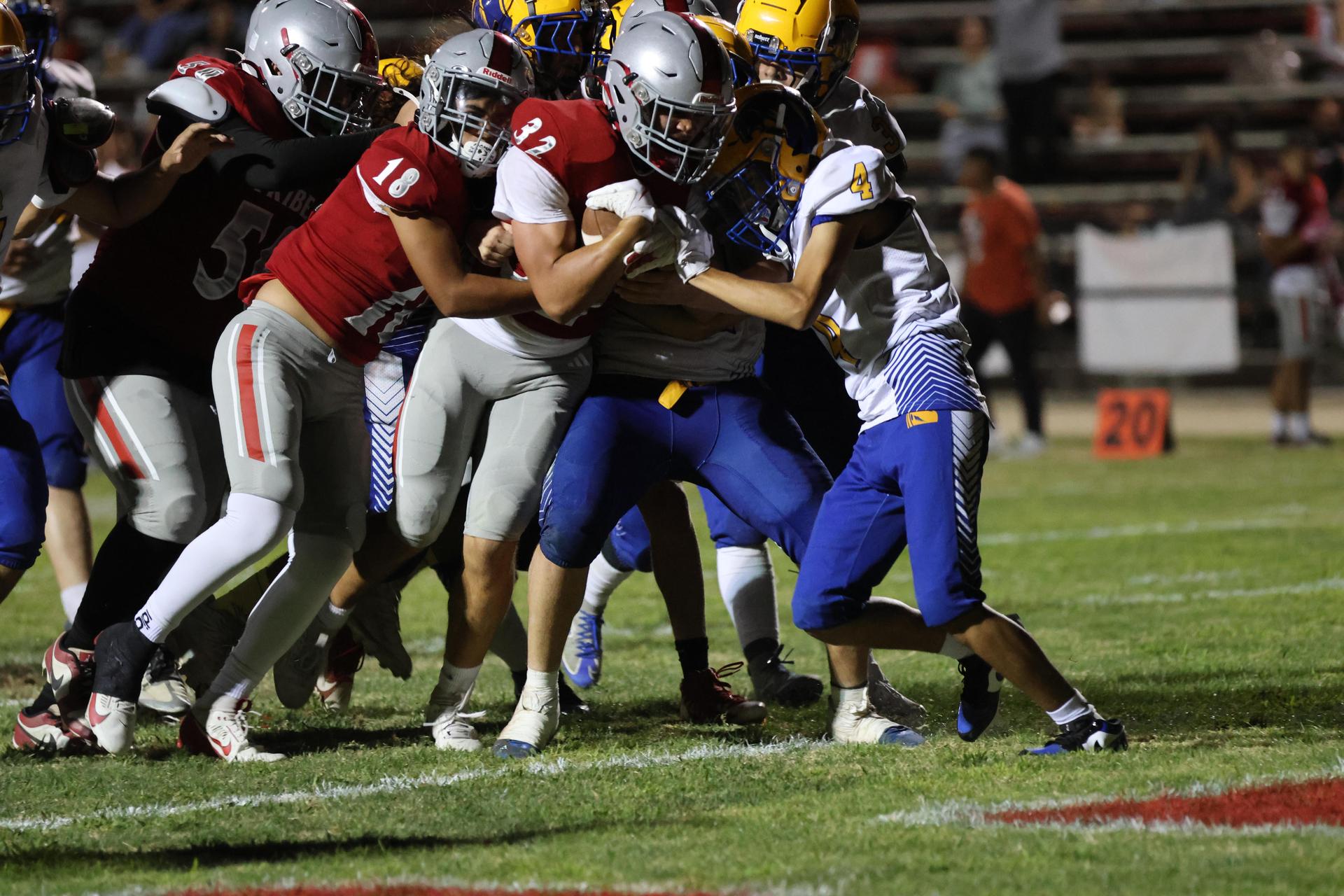 Varsity football players in action against Parlier 119